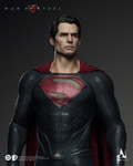 Side profile view of the Superman figure suspended on the flight stand with the wired cape flaring behind him.