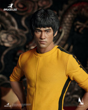 Front dynamic view showcasing the detailed yellow tracksuit and head sculpt of the INART Bruce Lee one sixth scale figure.