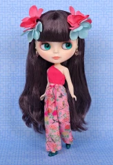 Close up photo highlighting the cocoa brown eyeshadow with rose pink corners, plump peach pink lips, and dark brown purple-tinged hair of the Jade Garden Blythe doll.  