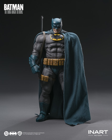 A close up photograph highlights the intricate details of the grinning head sculpt and the battle damaged chest emblem on the Batman figure.