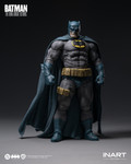 A close up photograph highlights the intricate details of the grinning head sculpt and the battle damaged chest emblem on the Batman figure.
