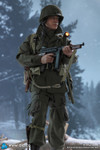 A full front view of the 1/6 scale Lieutenant Buck action figure wearing his authentic M42 paratrooper uniform and holding a Thompson submachine gun.