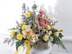 In shades of pink, yellow and soft blue, accented with sprigs of green, this basket arrangement conveys your deepest sympathies.
