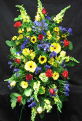 Enlongated spray of bright coloured flowers. A prestigious piece of flowers for family or a close friend