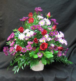 Burgundy and red tones make a rich tribute. Roses and assorted mauve and purple chrysanthemeums make a lovely jewel toned display.We deliver daily to all funeral home in the Toronto area.