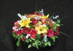 Beautifully arranged red silk flowers with yellow lillies. These flowers will attach to the gravestone. Sometimes called a tomb topper.These are artificial flowers.