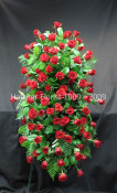 A beautiful red standing spray with 5 dozen Freedom eco roses.  A stunning piece from the family. We can use other cours of roses.