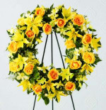 This beautiful wreath holds golden yellow roses, Asiatic lilies and alstroemeria against a background of assorted greenery. An expression of your friendship and sympathies.