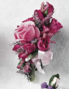 Corsage of deep pink roses and magenta alstroemeria.