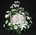 Send condolences to the home or office with a white tribute arrangement, which contains a keepsake book with the "Footprints" poem. A unique design we can have delivered for you in the Toronto area.
