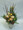 Golden Woodland a picture perfect combination of porcelina sweetheart roses, pine cone, cat tails, gold balls and Canadia pine and fir. designed in a rich golden ceramic container.