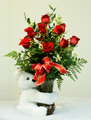 Lovely Valentine keepsake white bear 12 inches or 28cm.12 Red Freedom rose from Ecuador and mixed foliage. Cupid bow and heart pick.