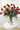 18 roses, limonium and seeded eucalyptus are beautifully arranged in a glass vase. Sure to impress. Available in pink, red, yellow, white or peach. red Freedom roses by Sierra Eco.