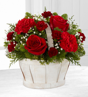 FTD® proudly presents the Better Homes and Gardens® Celebrate the Season™ Bouquet. Let their holiday season bloom with bright beauty when you send this simply sweet holiday flower arrangement. Rich red roses, red carnations and burgundy mini carnations are perfectly accented with Million Star Gypsophila and an assortment of lush holiday greens to create an eye-catching Christmas flower bouquet. Presented in an oval white wash woodchip basket to give it a wonderful winter inspired styling, this stunning flower arrangement is an incredible way to send your love and affection to friends and family throughout the month of December.