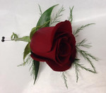 Classy classic red rose Boutonniere. We also do them in white, yellow, pink, purple/mauve and orange. The tikki fern adds a feathery touch. Call at least a week before you need your corsages and boutonnieres, please.