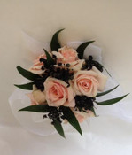 Sweetheart roses, ruscus, tulle and baby breath sprayed black. This was a custom design for specific dress. We made a matching boutonniere for the gentleman.  