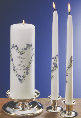 Real forget me not flowers are hand placed in a heart design on this unity candle.