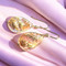On a background of pink silk, to better show the colours.