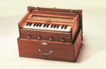 Beautiful Bina Harmonium - 23B - Deluxe Model with 2.5 Octaves made with dried Indian tun wood, this lovely model comes in teak colored wood.