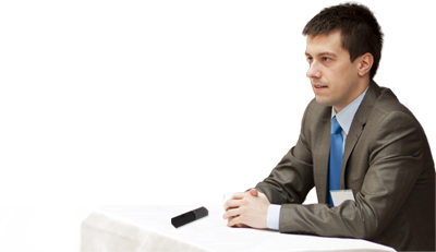 Conference speaker using Start-Stop PUMA wireless mic at table.