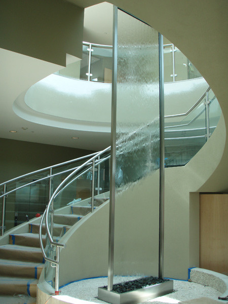 Tall glass custom indoor water feature. 
