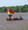 Red/yellow/blue/clear sail mounted on canoe