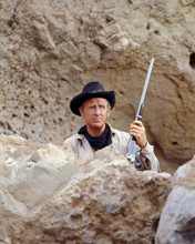LLOYD BRIDGES HOLDING RIFLE BEHIND ROCK PRINTS AND POSTERS 290384