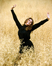 RAQUEL WELCH STRIKING POSE IN BLACK OUTFIT IN WHEAT FIELD PRINTS AND POSTERS 291367