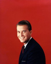 DICK CLARK ICONIC YOUNG IMAGE IN SUIT AGAINST RED STUDIO BACKDROP PRINTS AND POSTERS 292079