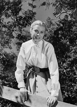 Grace Kelly poses next to fence circa 1950's Hollywood 5x7 inch photograph