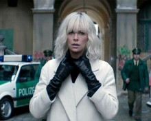 Charlize Theron wears black gloves and beige coat as Atomic Blonde 8x10 photo