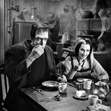 The Munsters Fred Gwynne as Herman with Lily at breakfast table 12x12 photo