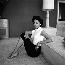 Dorothy Dandridge in sexy tight sweater sits on floor by sofa 12x12 photo