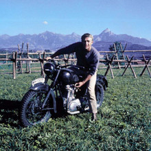 Steve McQueen on Triumph TR6 motorbike by fence The Great Escape 12x12 photo