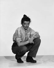 Katharine Hepburn in shirt and pants crouching on studio floor 12x18  Poster