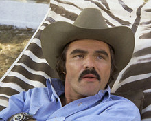 Burt Reynolds relaxing on hammock in blue shirt and cowboy hat 12x18  Poster