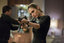 Gal Gadot looks tough aiming gun 8x10 photo