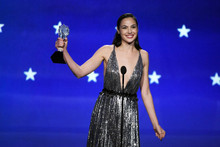 Gal Gadot in low cut dress smiling holding up awards 8x10 photo
