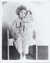 Shirley Temple cute seated pose in pajamas holding doll 8x10 photo