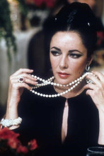 Elizabeth Taylor in black dress holds string of pearls 4x6 inch photo