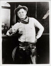 Will Rogers in western outfit holding glass of milk leaning on bar 8x10 photo