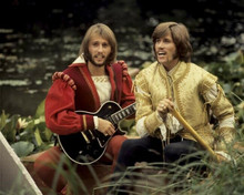 The Bee Gees 8x10 inch photo Robin and Barry 1960's outfits paddle canoe
