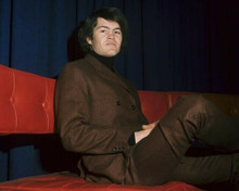 The Monkees Micky Dolenz in brown suit seated on sofa 8x10 inch photo
