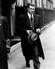 Cary Grant suave in long coat carrying hat outside London hotel c.1940's 8x10