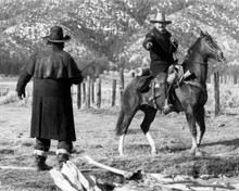 The Shootist John Wayne as J.B. Books on horseback pulling out gun 8x10 photo