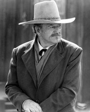 John Wayne as J.B. Books wearing western overcoat sat on horse The Shootist 8x10
