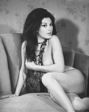 Edwige Fenech glamour pose on sofa wearing necklaces 8x10 photo showing legs