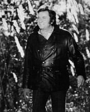 Johnny Cash c.1974 walking in woods wearing black leather jacket 8x10 inch photo