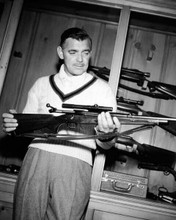 Clark Gable displays his gun collection in cabinet 8x10 inch photo