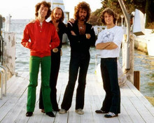 The Bee Gees brothers Barry Robin Maurice & Andy pose on boat dock 8x10 photo